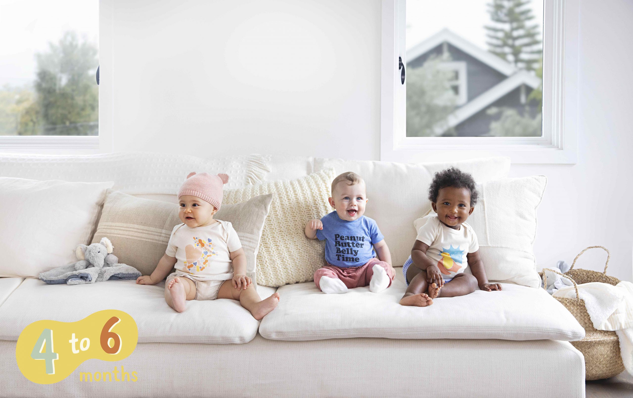 three babies sitting on a couch 