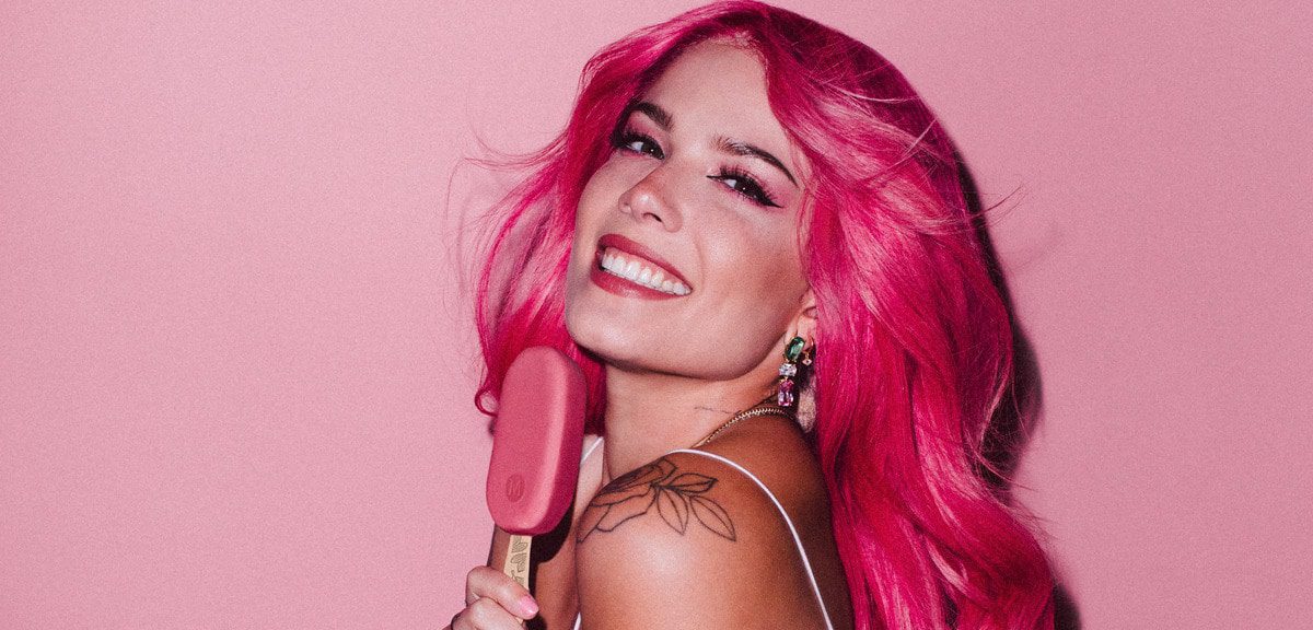 pop star, Halsey, smiling and holding a Magnum ice cream bar