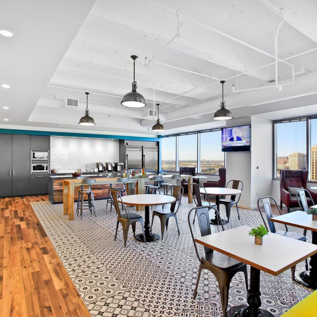 Golin Dallas cafeteria with black and white patterned tile and tables with industrial metal chairs