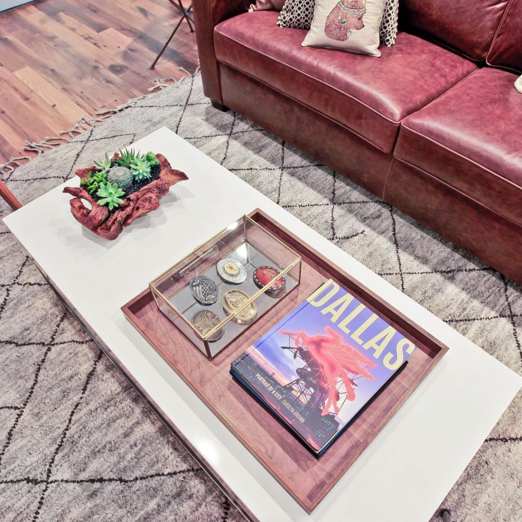 coffee table with tray containing a book titled 