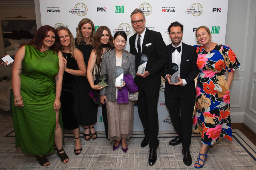Group photo of Golin team members celebrating at the PRWeek Global Awards ceremony, holding multiple awards while posing in front of a branded backdrop featuring PRWeek Global Awards and sponsor logos.