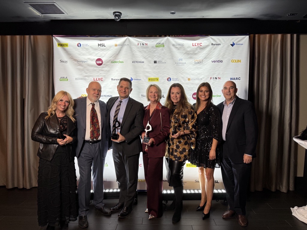 Group of Goliners standing against step and repeat at PRovoke Global SABRE Awards.